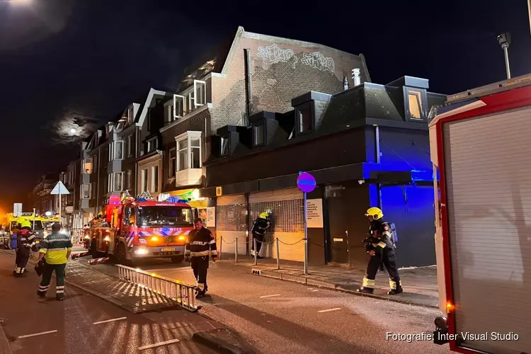 Brandweer redt twee mensen uit dakgoot bij brand